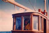Skipper in wheelhouse
