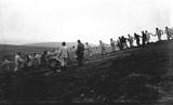 Group hauling gun on slope
