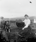 Man and woman with caddie lamb and dog