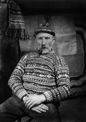 Johnnie Jamieson in patterned jumper and toorie