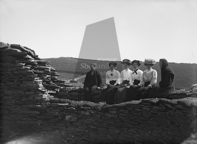 Group seated on wall head of the Broch of Mousa
