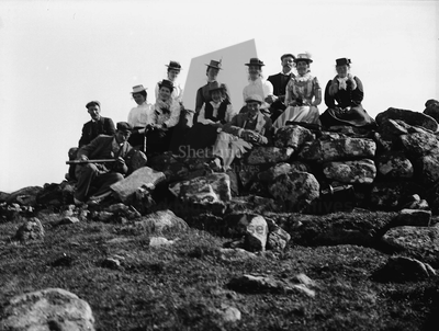 Group sitting on the Neolithic cairn on Vementry