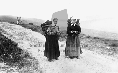 Two women carrying kishies