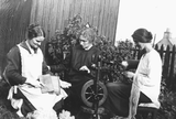 Women carding, spinning and knitting