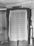 Lace shawl pinned up for display
