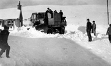 Snow plough clearing snow