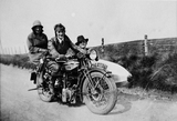 People on motorcycle and sidecar